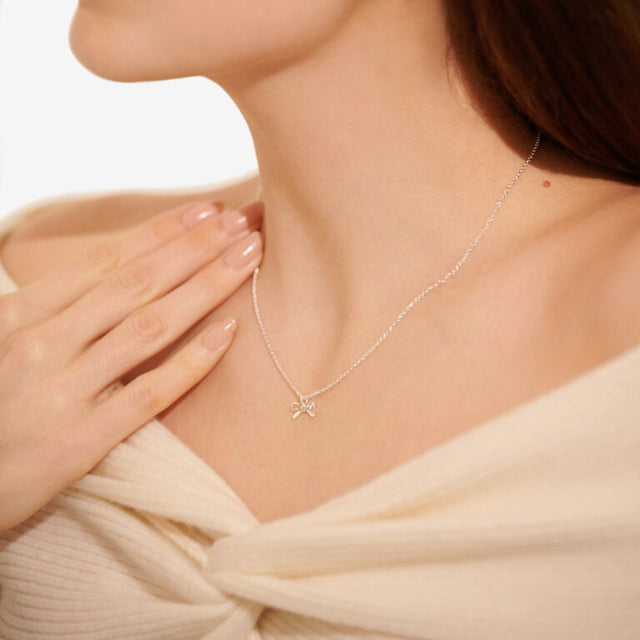 Our A Little Thank You Necklace features an elegant silver-plated chain and a sparkling bow charm. Perfectly presented on one of our signature stylised cards and framed by a sweet sentiment. This piece was made to be cherished now and for years to come.
