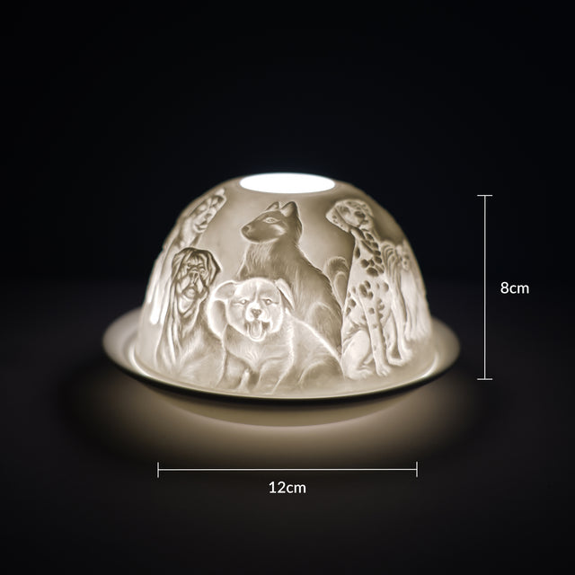Cello porcelain tealight holder dome featuring different breeds of dogs all over the dome. Dimensions: 8cm height, 12cm width, displayed against a dark background.