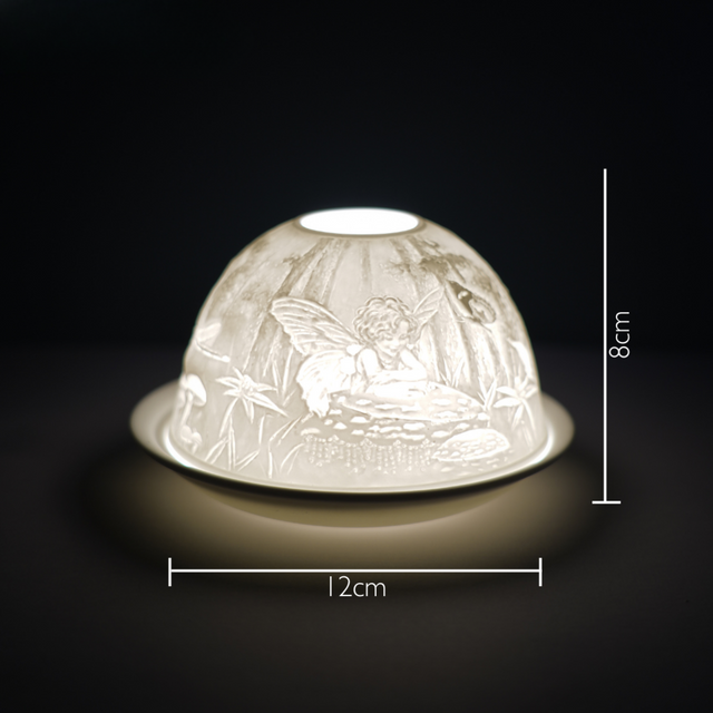 Cello porcelain tealight holder dome featuring a fairy surrounded by nature. Dimensions: 8cm height, 12cm width, displayed against a dark background.