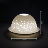 Cello porcelain tealight holder dome featuring stars scattered over the surface of the dome. Dimensions: 8cm height, 12cm width, displayed against a dark background.