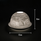 Cello porcelain tealight holder dome featuring a lion surrounded by its cubs. Dimensions: 8cm height, 12cm width, displayed against a dark background.