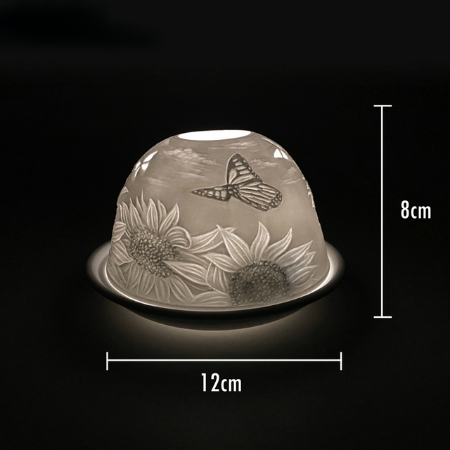 Cello porcelain tealight holder dome featuring a butterfly landing on a sunflower. Dimensions: 8cm height, 12cm width, displayed against a dark background.