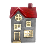 tealight holder house with a red roof and gold accents on a white background