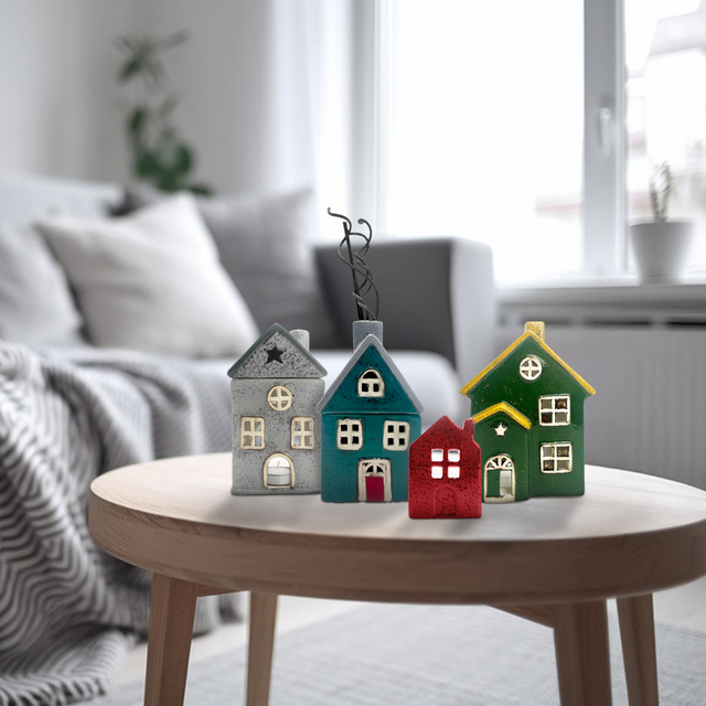 Assorted Cello Homes ceramic tealight houses, including Cello home candle - fresh linen, styled together on a coffee table for cosy home décor.