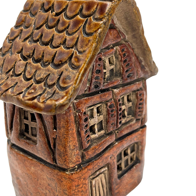 Close-up of the orange Briarwood Hollow village pottery house showing fine ceramic detailing and glazed roof texture.