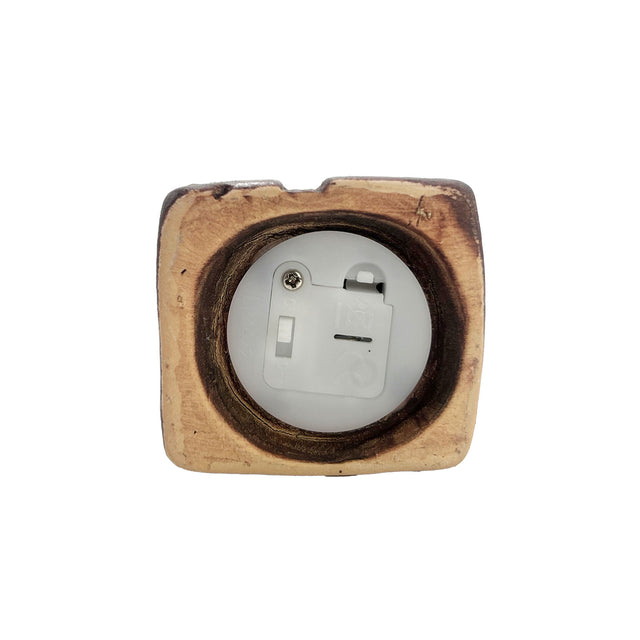 Close-up of the base of the Gatekeeper’s Lodge pottery house showing the LED battery compartment and on/off switch design.