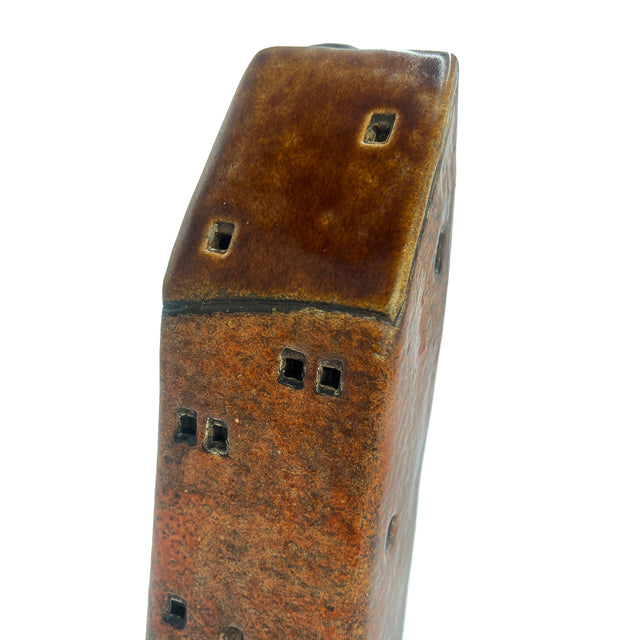 Close-up of the Gatekeeper’s Lodge pottery house roof and wall, highlighting the artisan ceramic glaze and hand-cut window detailing.