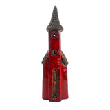 Front view of the Crimson Tower village pottery house in crimson ceramic with tall pointed roof and narrow arched door.