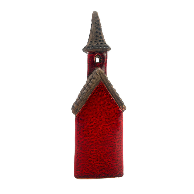 Rear view of the Crimson Tower red ceramic LED house showing textured glaze, roof detail, and window openings.