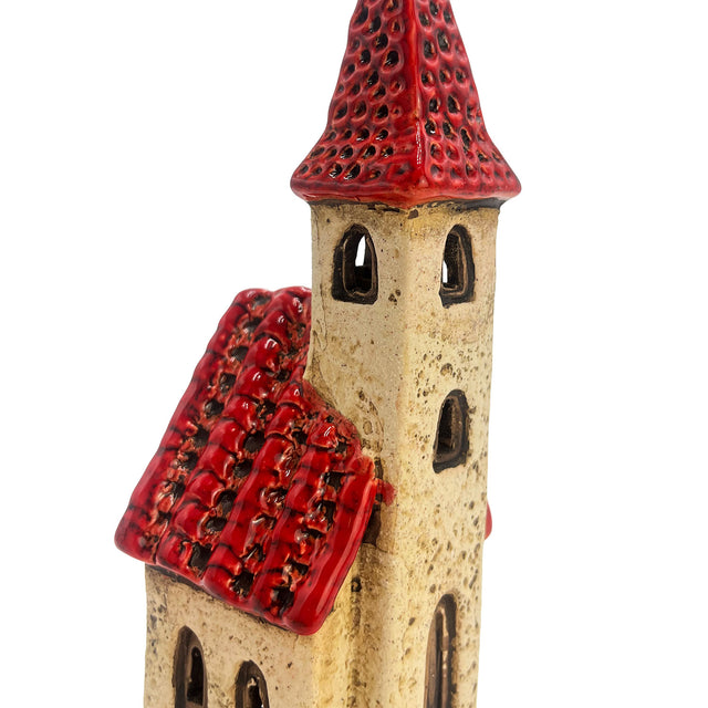 Close-up of the Ivory Tower handcrafted ceramic house showing red roof tiles, arched windows, and textured ivory glaze.