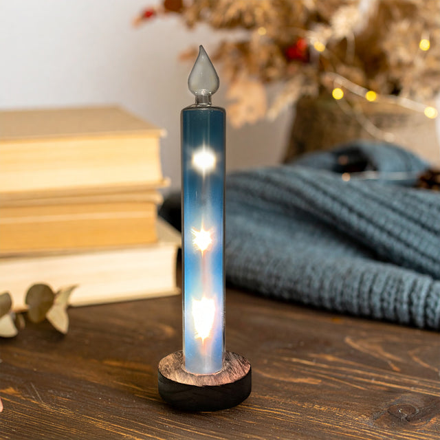 Blue Gleneagles Moving Stars LED USB Glass Candle illuminating a decorated Christmas living room with soft moving star lights, adding a magical and serene festive glow.