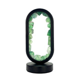 Front view of Gleneagles Oval Earth LED Lamp – Green Fluorite showing sleek oval glass design with softly glowing natural green crystal.