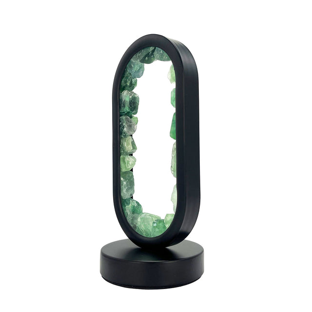 Side view of Gleneagles Oval Earth LED Green Fluorite Lamp glowing with calming green light, showing crystal clarity and smooth oval glass finish.