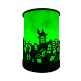 Haunted House Colour-Changing Electric Melt Burner by Cello glowing green, adding an enchanting, ghostly touch to Halloween home styling.