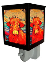 Cello Highland Cow Plug In Electric Melt Burner illuminated, showcasing stained-glass-style light and rustic cow design for cosy home fragrance