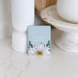 Small rectangular ceramic magnet with floral design and text on a marble surface as unique gift for mother's day
