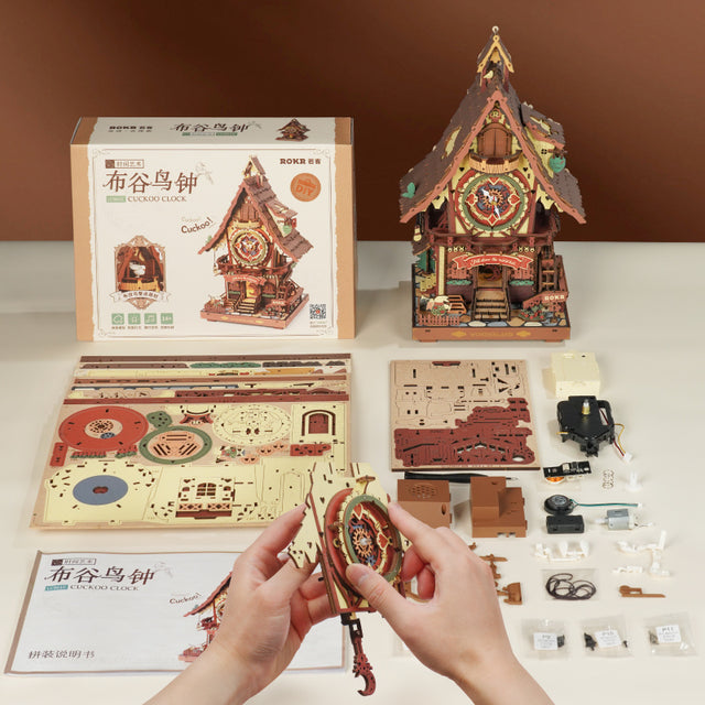 LC901C Wooden cuckoo clock ROKR Models kit with packaging and components on a table Robotime