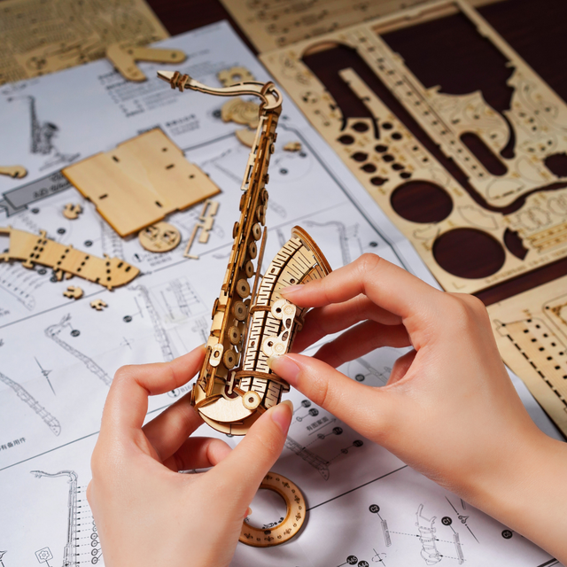 Wooden ROBOTIME Rolife Kits Saxophone TG309 being assembled on instructions