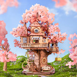 Rolife kits Sakura Tree House miniature displayed in garden setting with cherry blossom details