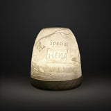 Cello Tall Tealight Dome Special Friend glowing porcelain candle holder on dark background.