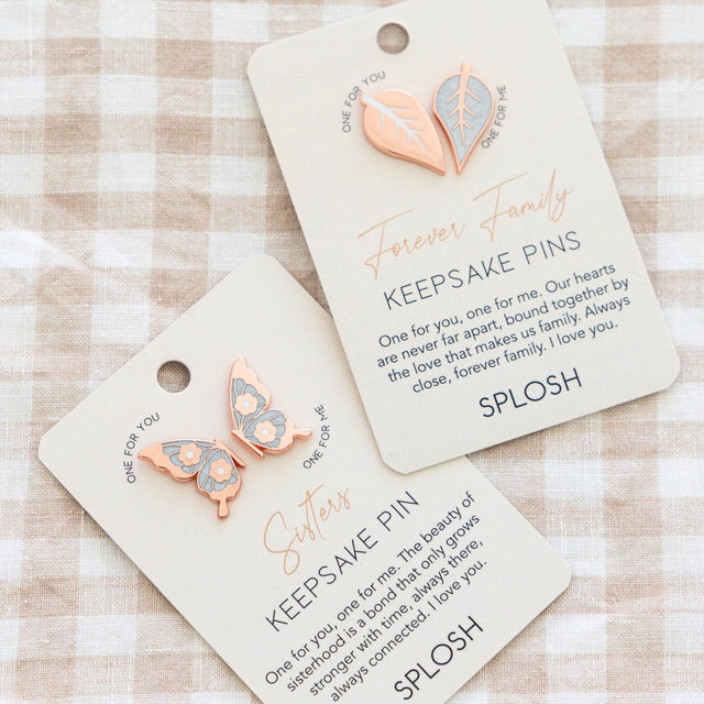 Sisters keepsake pin placed beside the printed sentiment card