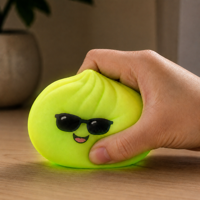 Mystery Neon Glow in the Dark Bao Bun Squishy being squeezed in hand for stress relief, anxiety reduction and sensory play