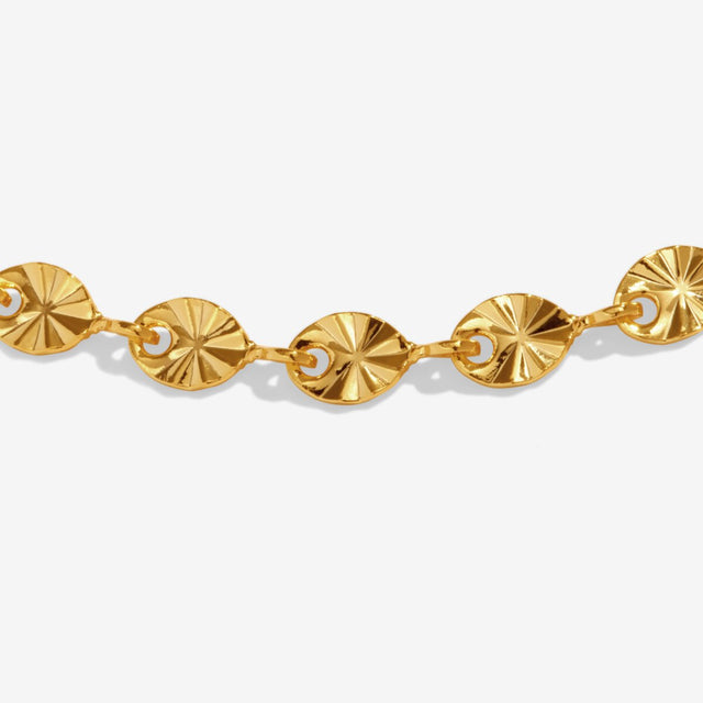 Close-up detail of textured sparkle chain on gold anklet