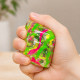 Graffiti Cube squishy fidget toy being squeezed for stress relief, anxiety reduction and improved focus