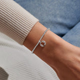 Joma Jewellery A Little ‘The World Needs More People Like You’ silver bracelet worn on wrist