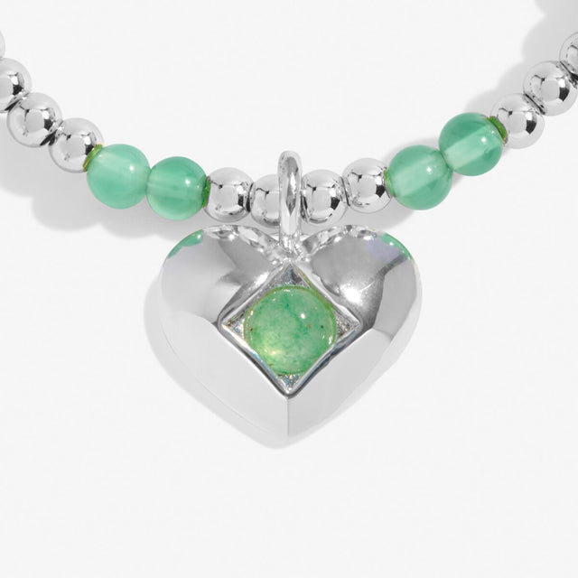 Close-up of aventurine birthstone heart charm on Joma Jewellery bracelet