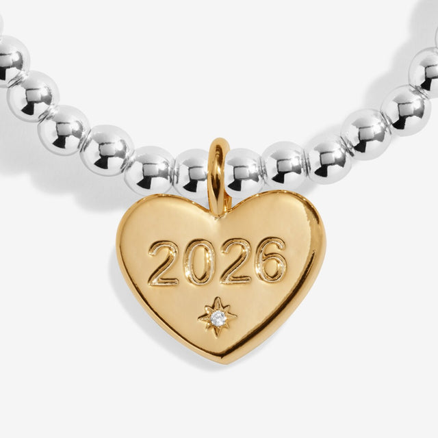 Close-up of gold heart charm engraved 2026 on Joma Jewellery bracelet