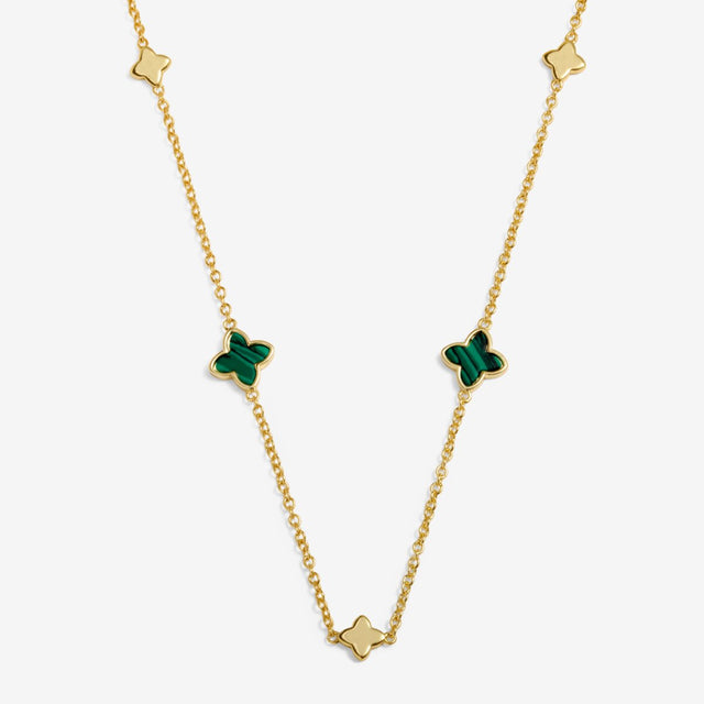 Clover gold necklace laid flat showing green clover charms