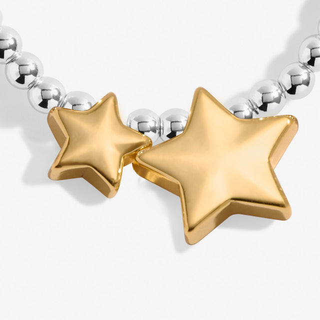 Close up of gold star charms on silver beaded congratulations bracelet
