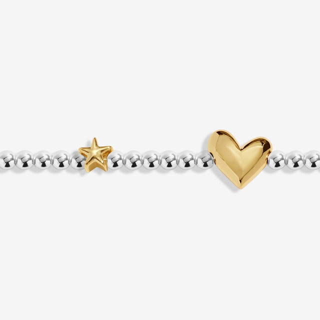 Close-up of heart charm on Joma Jewellery December birth month bracelet