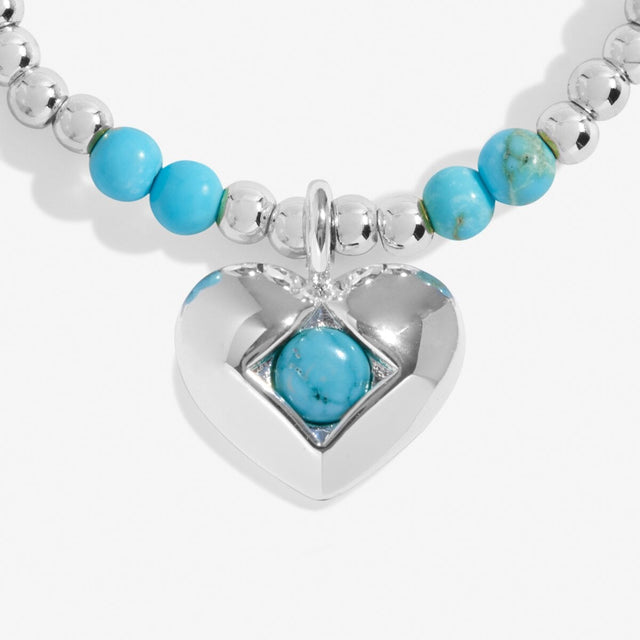 Close-up of turquoise birthstone heart charm on Joma Jewellery bracelet