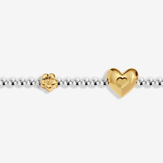 Close-up of gold heart charm on Joma Jewellery February bracelet