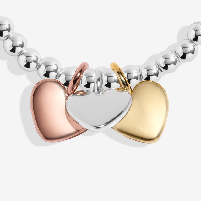 Close-up of silver gold and rose gold heart charms Friendship bracelet