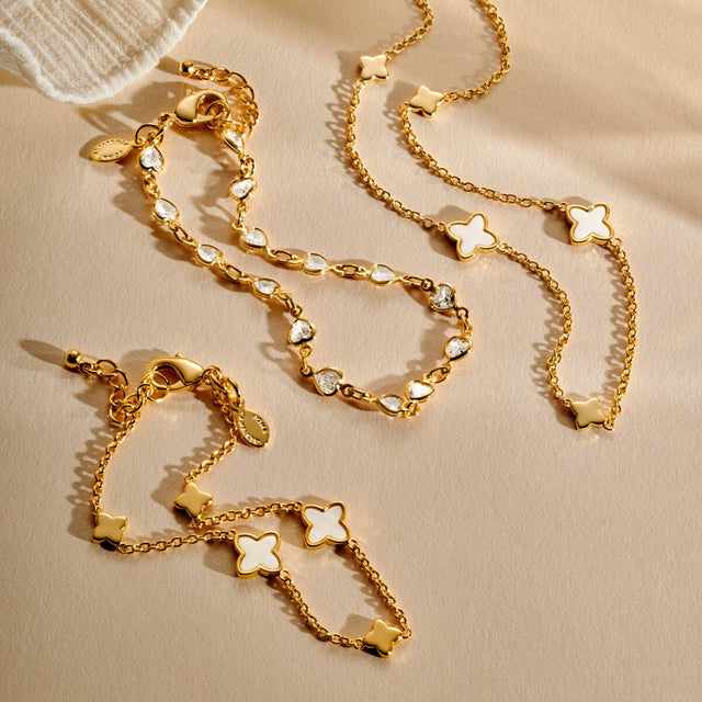 Gold clover bracelet laid flat showing chain and clover charms