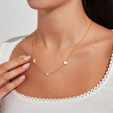 Gold clover necklace worn on collarbone from Joma Jewellery Loved By You collection