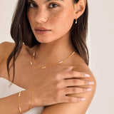 Gold pearl bracelet styled with matching necklace