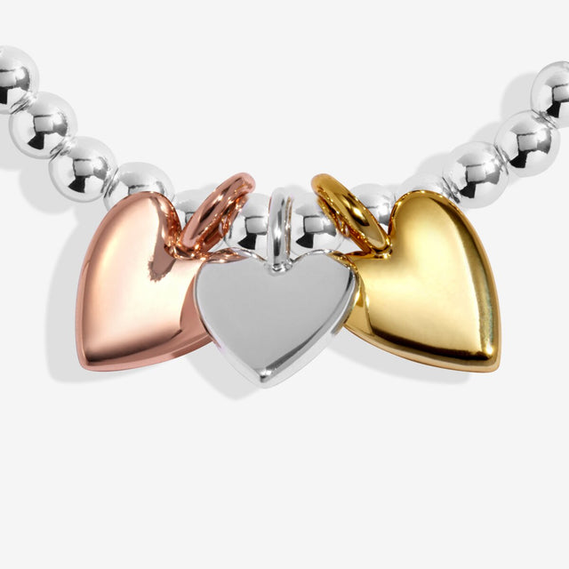 Trio heart charms in silver, gold and rose gold plating on beaded bracelet