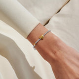 Joma Jewellery July birth month silver and gold-plated bracelet worn on wrist