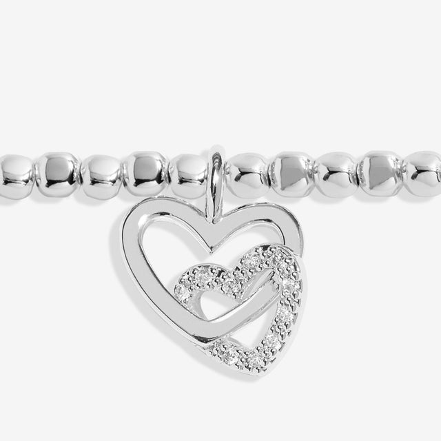 Close up of interlinked heart charms on silver mum bracelet