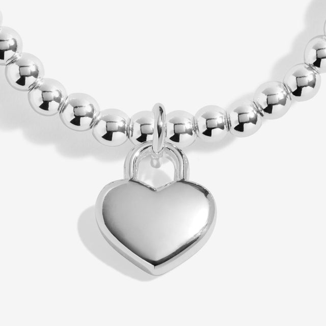 Close-up of silver heart charm on Joma Lots Of Love bracelet