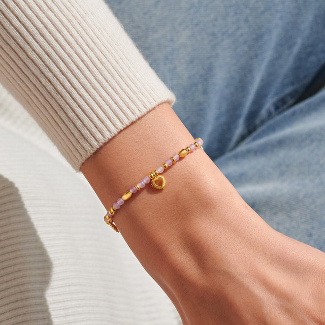 Gold Joma Jewellery Love affirmation bracelet worn on wrist