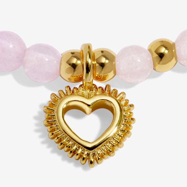 Close-up of gold heart charm on Joma Jewellery Love affirmation bracelet
