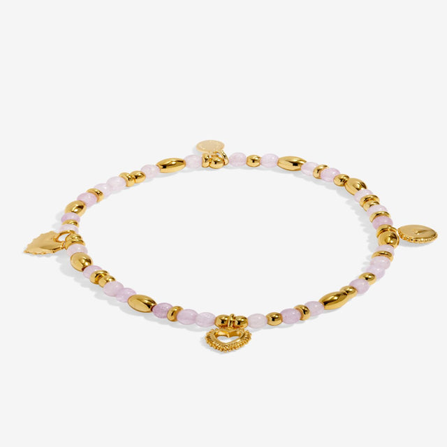 Flat lay of gold Joma Jewellery Love affirmation bracelet with gemstone beads