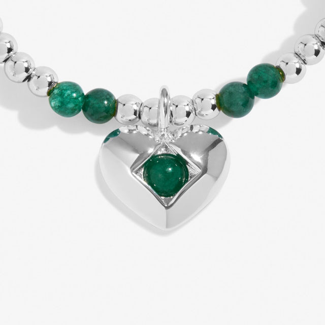 Close-up of green agate birthstone heart charm on Joma Jewellery bracelet