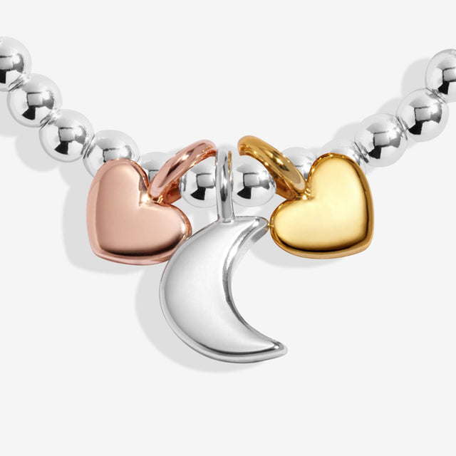 Trio charm detail with moon and heart charms in silver, gold and rose gold plating