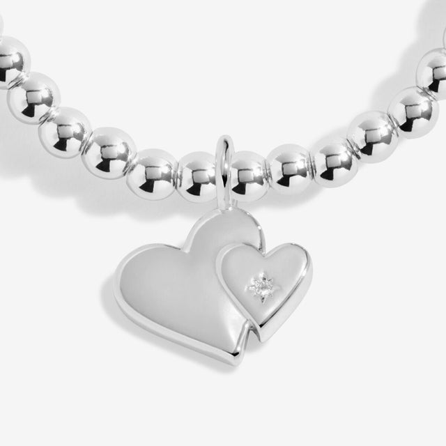 Close up of two linked heart charms on silver Mother’s Day bracelet